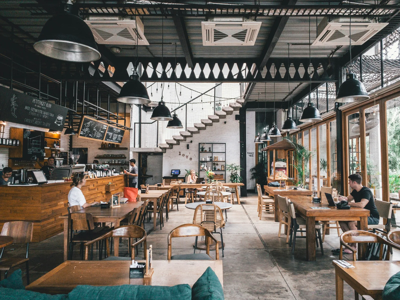 Warm and welcoming Urban Bites dining area filled with happy customers enjoying pizza together