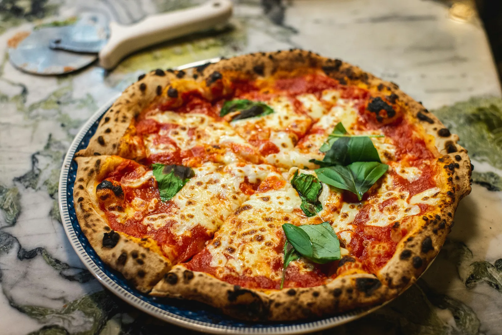Urban Bites pizza dough being hand-stretched by skilled chef, showcasing artisan craftsmanship