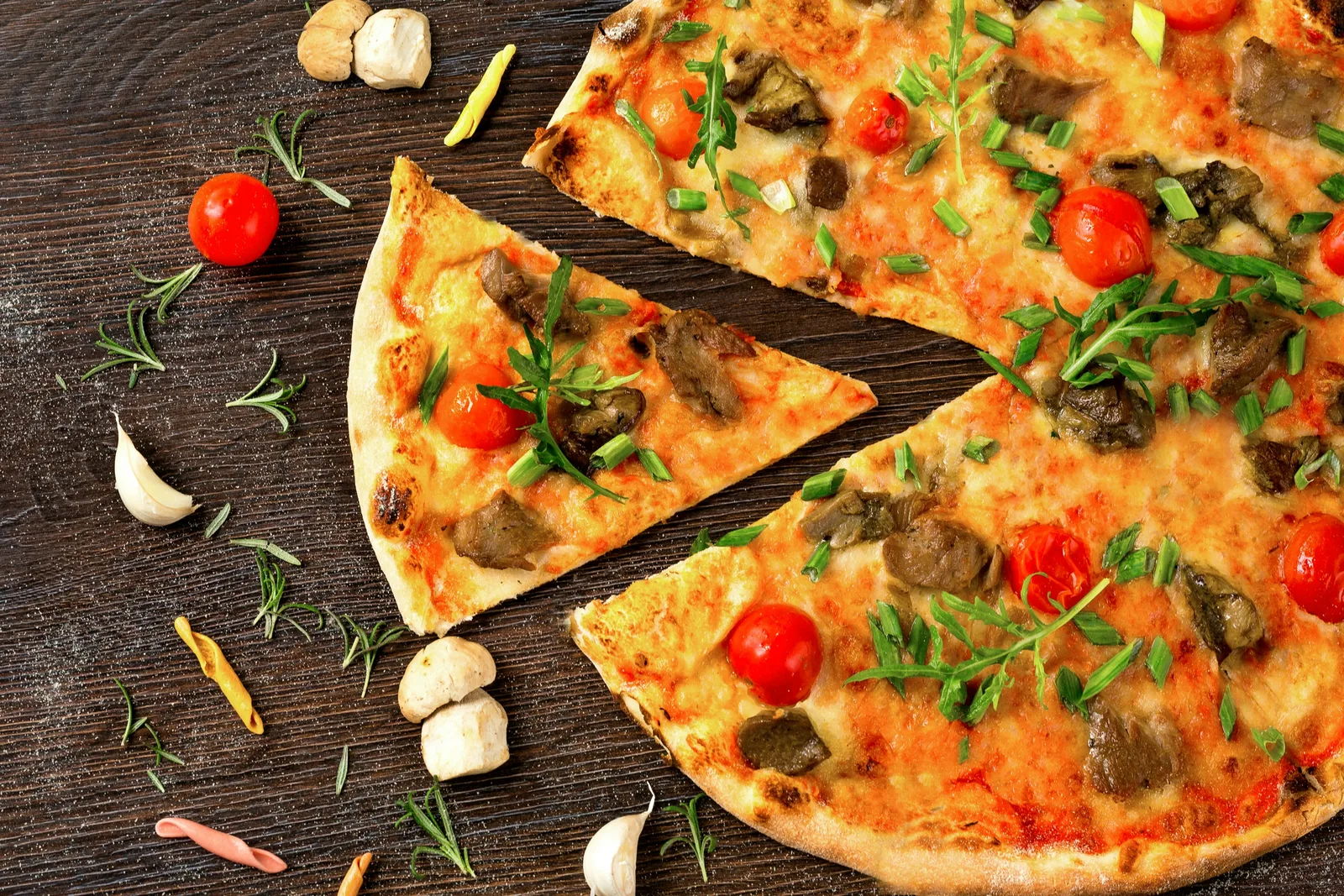 Close-up of a perfectly sliced Urban Bites pizza with melted cheese and colorful fresh toppings
